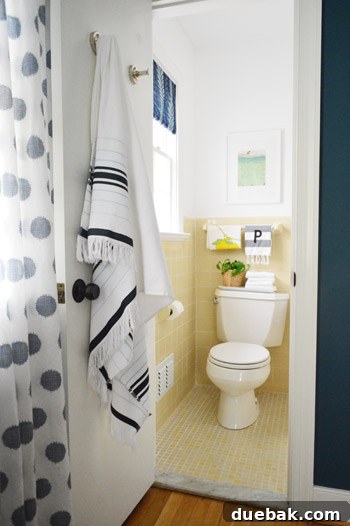 Guest bathroom with frosted window and fabric shade