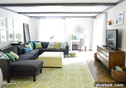 Living room with gray-washed beams and new rug