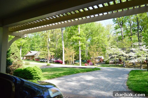 Carport pergola framing a view of the blooming street