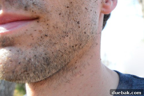 Dirt-speckled face of the pressure washer operator