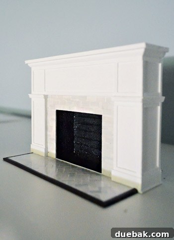 A close-up view of the intricately detailed miniature fireplace, showcasing the craftsmanship and lifelike features.
