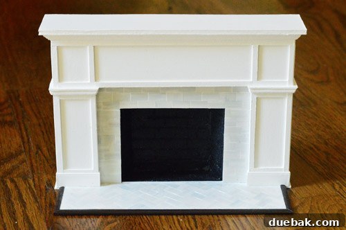 The miniature fireplace from a wider angle, highlighting its realistic textures and perfect proportions.