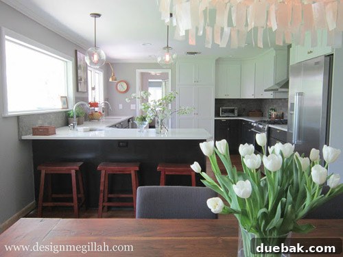 Open concept kitchen with two-tone cabinets, breakfast bar, and expanded counter space after renovation.