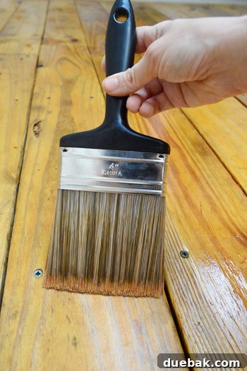Deck Restoration: A Comprehensive Guide to Staining and Sealing 11 Applying deck stain with a sponge applicator
