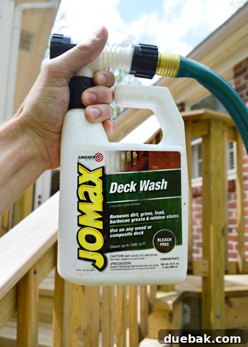 Deck Restoration: A Comprehensive Guide to Staining and Sealing 5 Hand holding a deck cleaner bottle with hose attachment