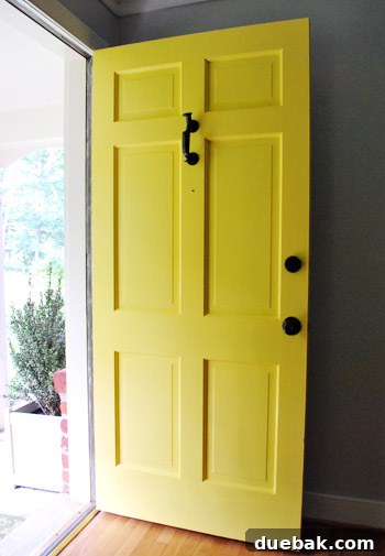 Yellow Front Door Open To Brick Ranch For Sale