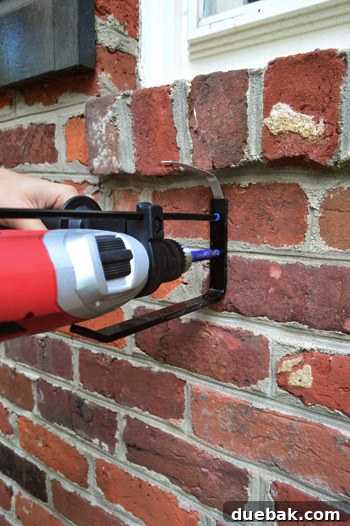 Mounting window box brackets on brick