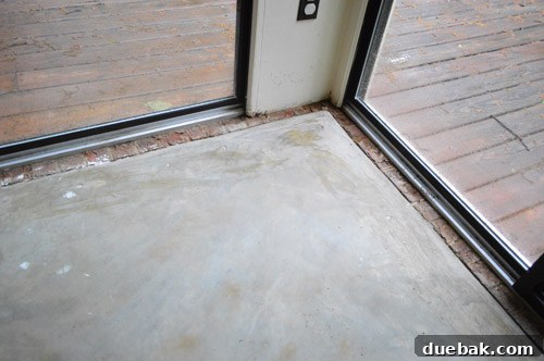 Removing Carpet, Padding, and Tack Strips 7 Clean concrete floor in sunroom after carpet removal
