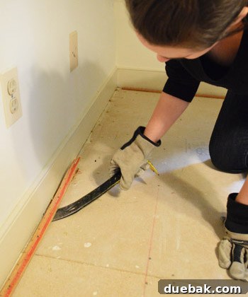 prying up carpet tack strip with crowbar