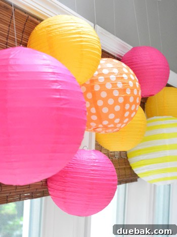 Dragon's Lair Birthday Bash 12 A charming display of pink, orange, and yellow paper lanterns hanging as decorations for a dragon birthday party.