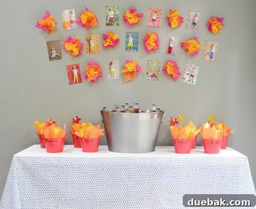 Dragon's Lair Birthday Bash 13 A drink and favor station at a dragon-themed birthday party, adorned with vibrant tissue paper 'fire' and framed photos.