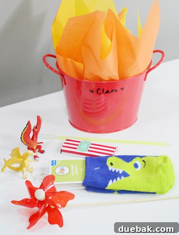 Dragon's Lair Birthday Bash 15 The contents of dragon birthday party favors, including pinwheels, dragon socks, dragon figurines, and crayons, neatly arranged.