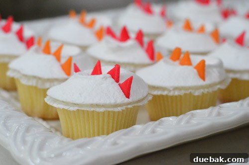 Dragon's Lair Birthday Bash 22 Close-up of vibrant cupcakes decorated with edible dragon scales made from candy, perfect for a dragon-themed birthday party.