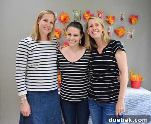 Dragon's Lair Birthday Bash 25 Three women in matching striped black and white shirts smiling at a birthday party, creating a fun, spontaneous moment.