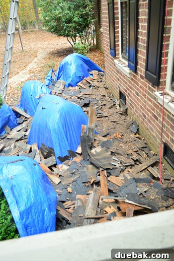 Major Home Upgrades: Furnace and Roof 5 House exterior during roof replacement, with scaffolding and debris visible.
