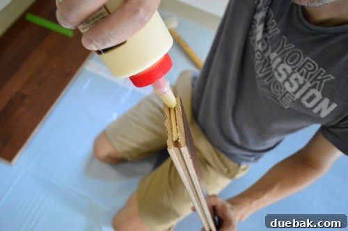 Elevate Your Space: A Seamless Guide to Oak Hardwood Flooring 13 Applying Wood Glue to Hardwood Planks