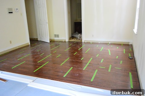 Elevate Your Space: A Seamless Guide to Oak Hardwood Flooring 14 Taped Hardwood Boards During Installation