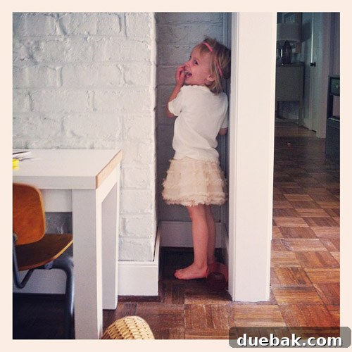Clara enjoying her favorite hiding spot in the old house, illustrating childhood innocence.
