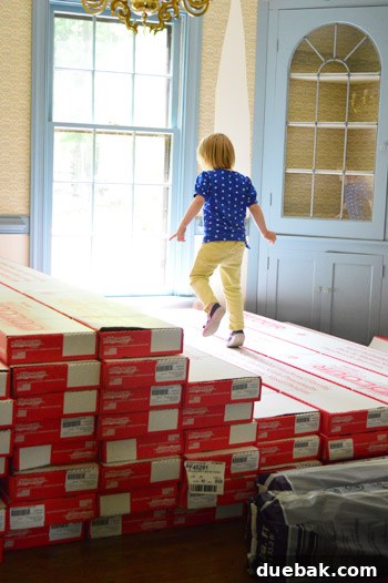 Boxes of hardwood flooring stacked in a dining room for acclimation
