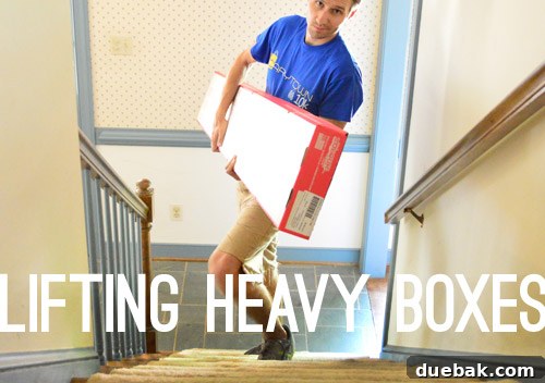 A stack of heavy hardwood flooring boxes in a dining room, ready to be carried upstairs for installation.