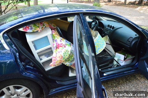Third Home, First Footprint 14 A car interior packed efficiently with moving boxes and smaller household items, illustrating the phased moving approach