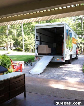Third Home, First Footprint 16 Professional movers carrying a large, heavy piece of furniture into the new house, illustrating efficient hired help for big items