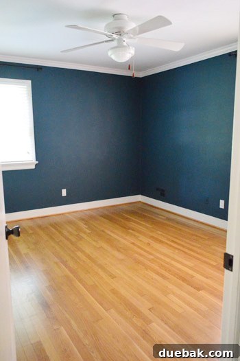 Closing the Chapter on Our Second Home 23 Empty guest room after dark teal paint and crown molding installation