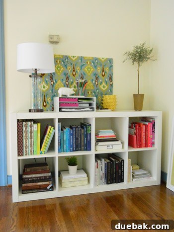 Close-up of a bookcase with books organized by color, showcasing vibrant spines.