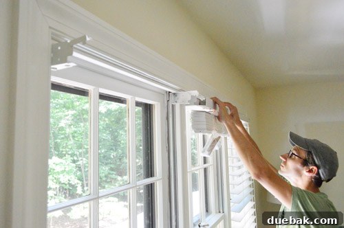 Effortlessly Install White Faux Wood Window Blinds 4 Close-up of a faux wood blind being installed into a window frame