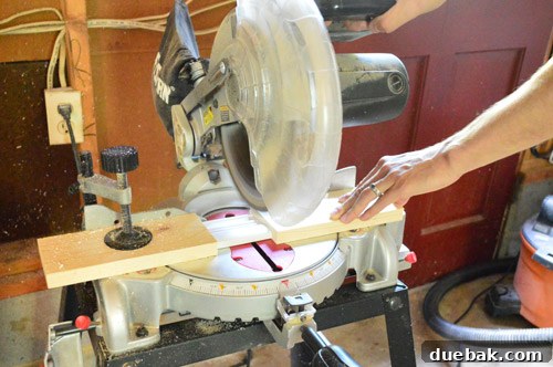 Effortlessly Install White Faux Wood Window Blinds 8 Using a miter saw to trim a faux wood blind's side piece, with safety blocking