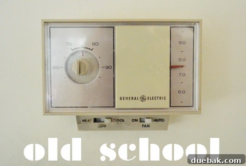 Close-up of the old thermostat before removal