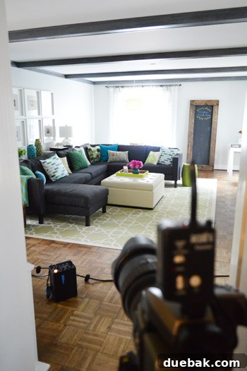 The HGTV Effect 20 Sectional couch piled with pillows, styled for a magazine