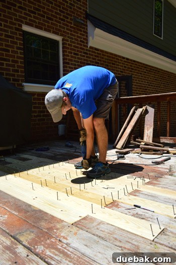 John screwing in new deck boards