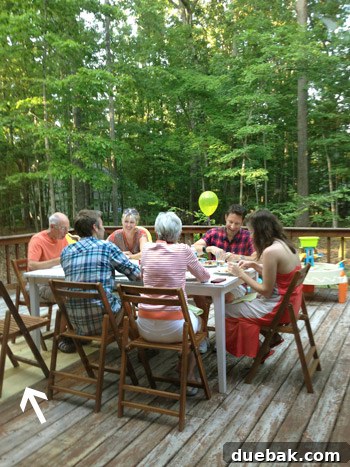 Gathering of people on patched hole in wooden deck