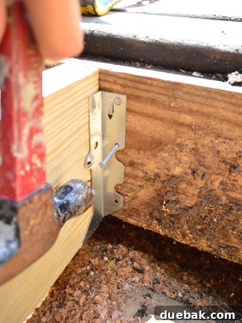 Nailing in metal hangers to repair a hole in the deck