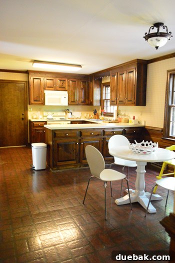 First Chapter 3 Kitchen interior, one month post-move, showing existing cabinets and temporary dining setup.