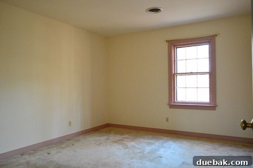 First Chapter 21 Spare room before renovations, with mauve trim and carpeting.
