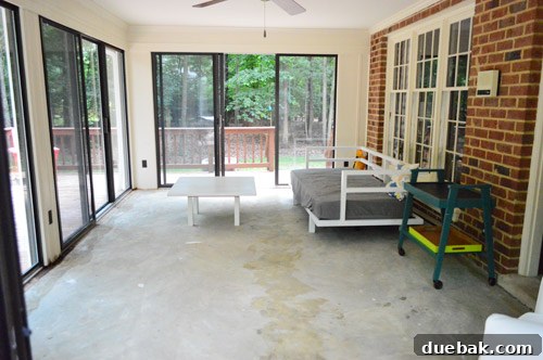 First Chapter 7 Sunroom interior, showing light-filled space and current flooring post-carpet removal.