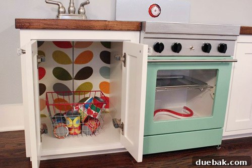 Detailed view of the play kitchen stove during construction, showing two main parts