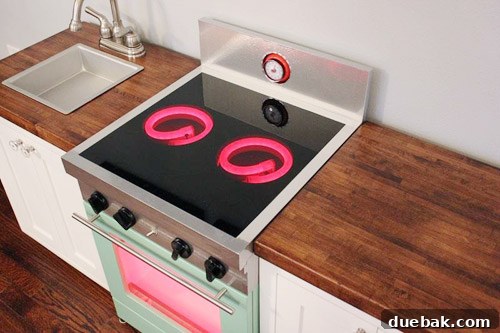 Completed play kitchen stove with dimmable LED burners glowing, showcasing stainless finish