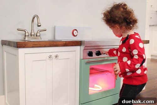 Zoey delightedly playing with her custom play kitchen, showing the overall aesthetic