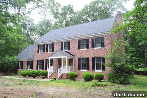 Exterior view of the house from a different angle, showcasing new paint and updated features