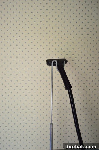 Close-up of old blue floral wallpaper in the foyer