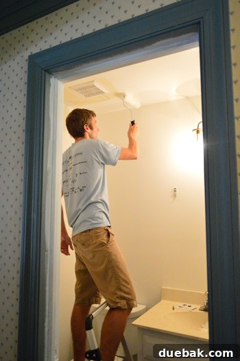 Priming and Painting Your Bathroom 10 John rolling paint on the freshly primed bathroom walls.