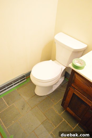 Priming and Painting Your Bathroom 7 Blue trim taped off, preparing for painting, protecting the slate floor.