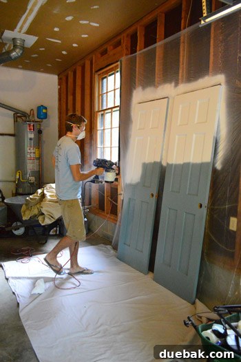 Hand-Painting Trim for a Professional Finish 3 Door being painted with a spray painter