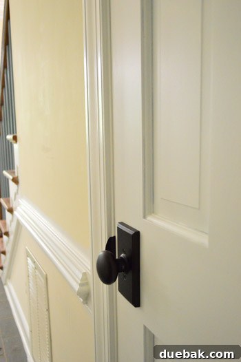 Hand-Painting Trim for a Professional Finish 7 Newly painted white doors and trim in foyer