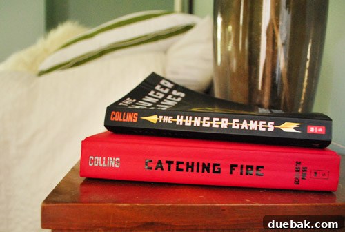 Peeta-siks: The Hunger Games & Hunger Names 2 A person holding a copy of The Hunger Games book, hinting at their excitement for the series.