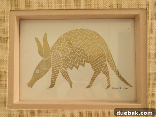 Close-up of golden armadillo print framed in a bathroom