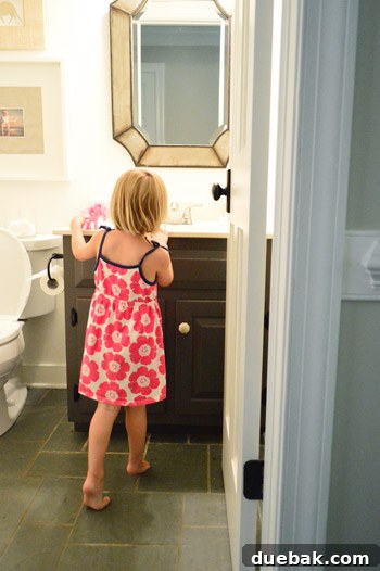 DIY Bathroom Faucet Replacement 13 Clara, a young child, admiring the newly installed faucet in the half bathroom